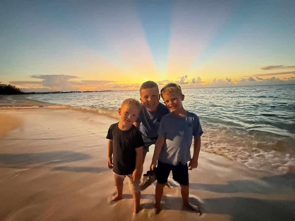 Dylan Dreyer and Brian Fichera's sons Calvin, Oliver and Rusty pose for a photo on a beach with the sunset behind them, shared on Instagram