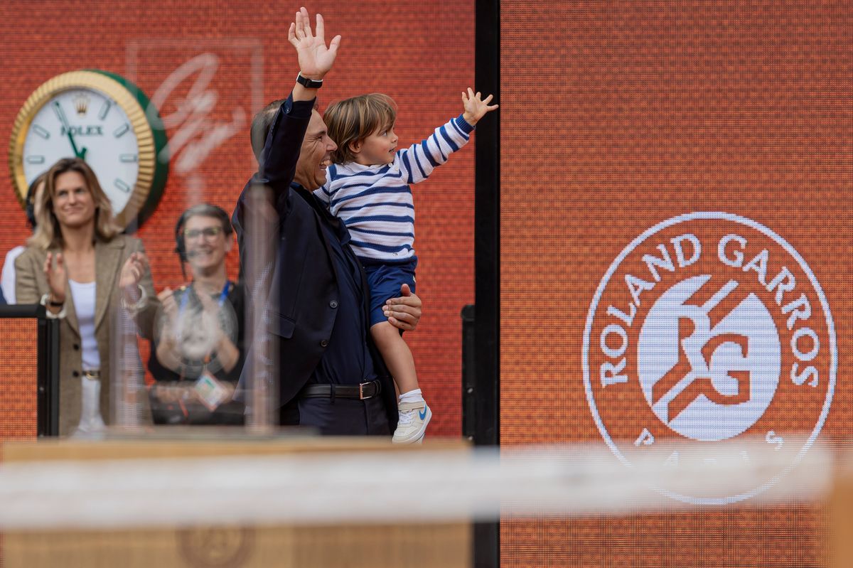 Rafael Nadal of Spain and his child say goodbye after the ceremony at the Roland Garros Grand Slam Tournament on May 25, 2025, in Paris, France.