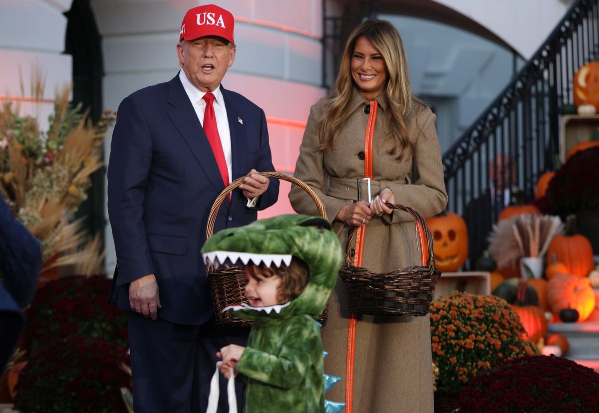WASHINGTON, DC - OCTOBER 30: U.S. President Donald Trump and first lady Melania Trump handout candy to children during the annual Halloween at the White House event on the South Lawn of the White House on October 30, 2025 in Washington, DC. The President and first lady welcomed military, law enforcement, and foster and adoptive families, as well as administration officials and their children, to the annual trick-or-treat celebration on the White House grounds. (Photo by Alex Wong/Getty Images)