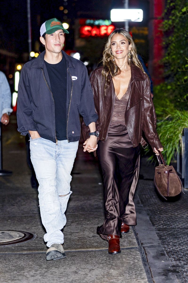 Jessica Alba stunned in a chocolate-brown satin dress complemented by a matching leather jacket, while Ramirez kept things casual in ripped jeans and a cap.