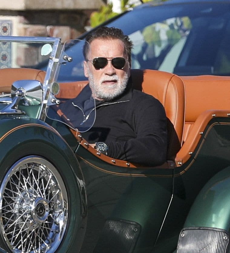 Arnold Schwarzenegger beams while cruising in a classic Mercedes convertible