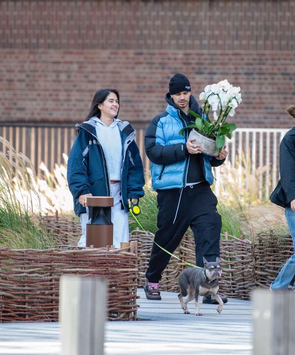 The couple were seen shopping together, with Romeo carrying a large potted flower while Kim walked alongside him with her small dog.