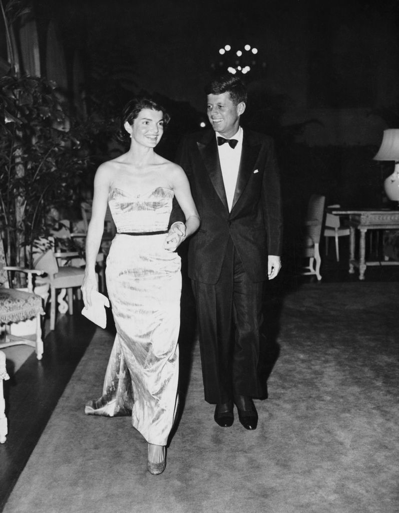 Senator John F. Kennedy walking with wife, Jackie, at the Senate Office Building.