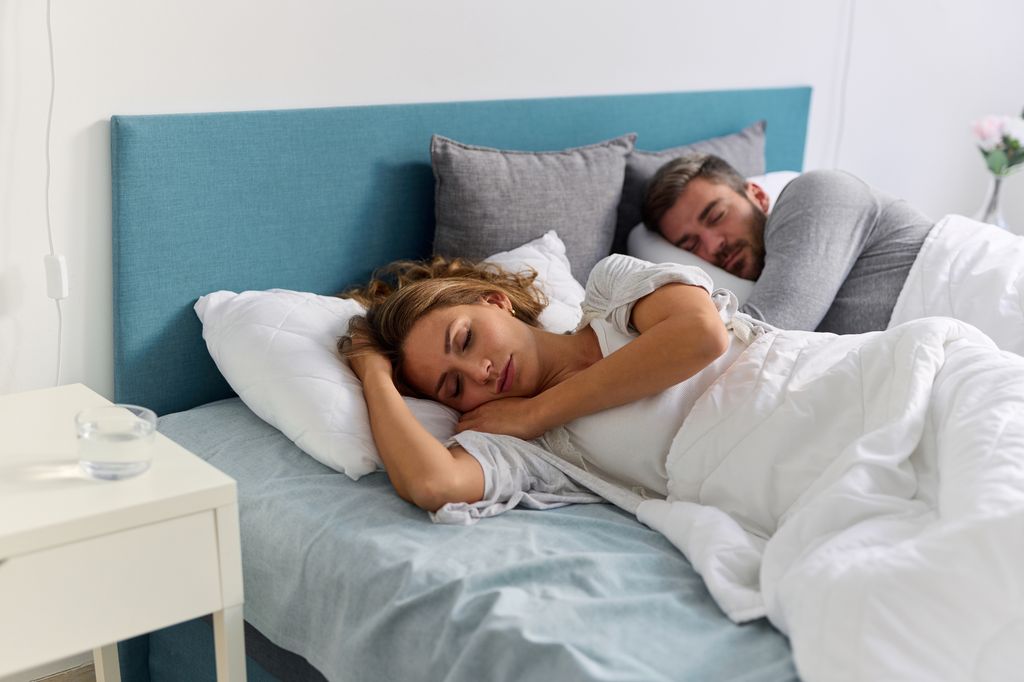 Couple sleeping peacefully in their bed at home