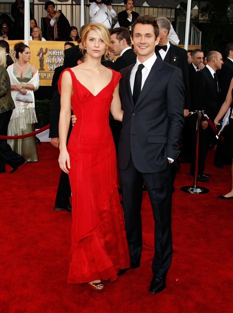 Claire Danes in red dress and Hugh Dancy in suit on red carpet