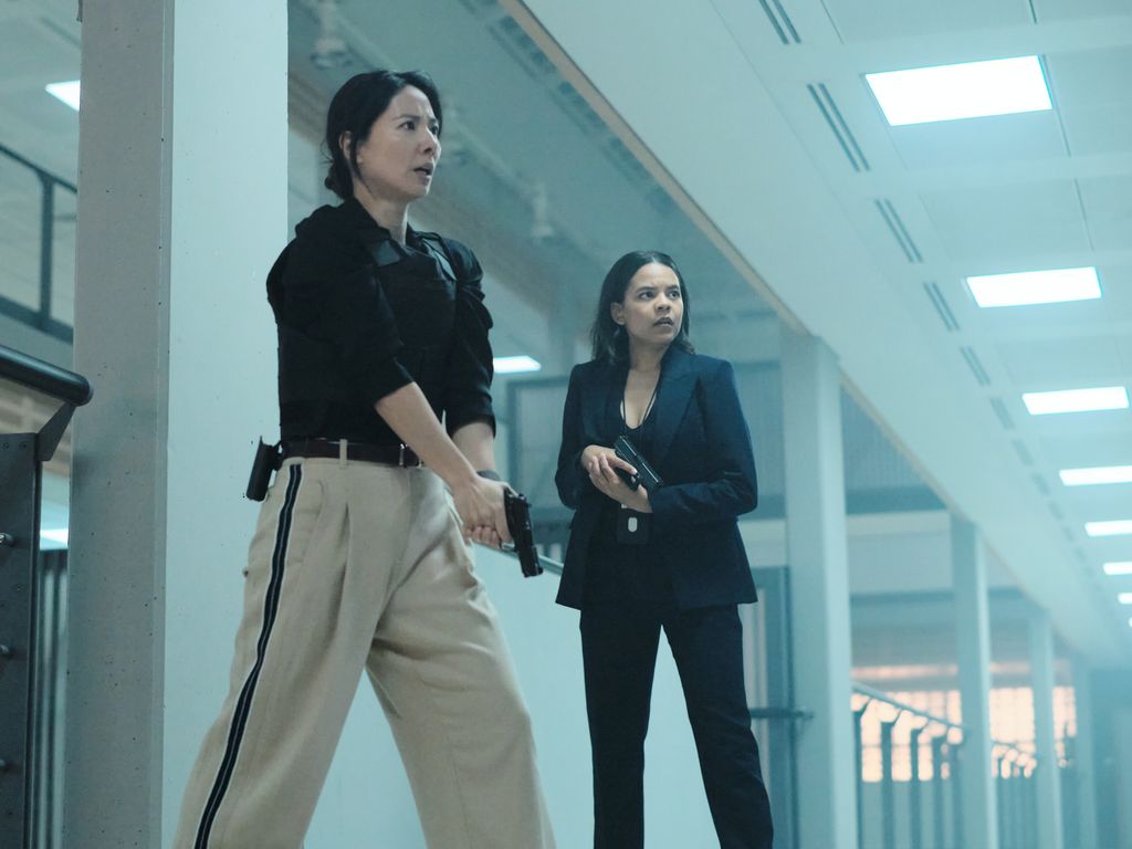 two women holding guns