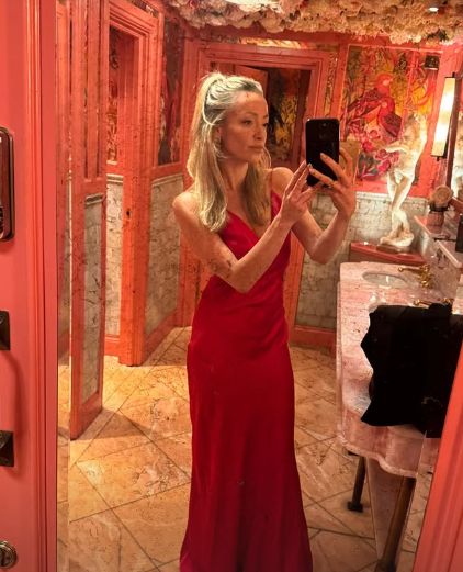 Cherry Healey taking a selfie in a red dress