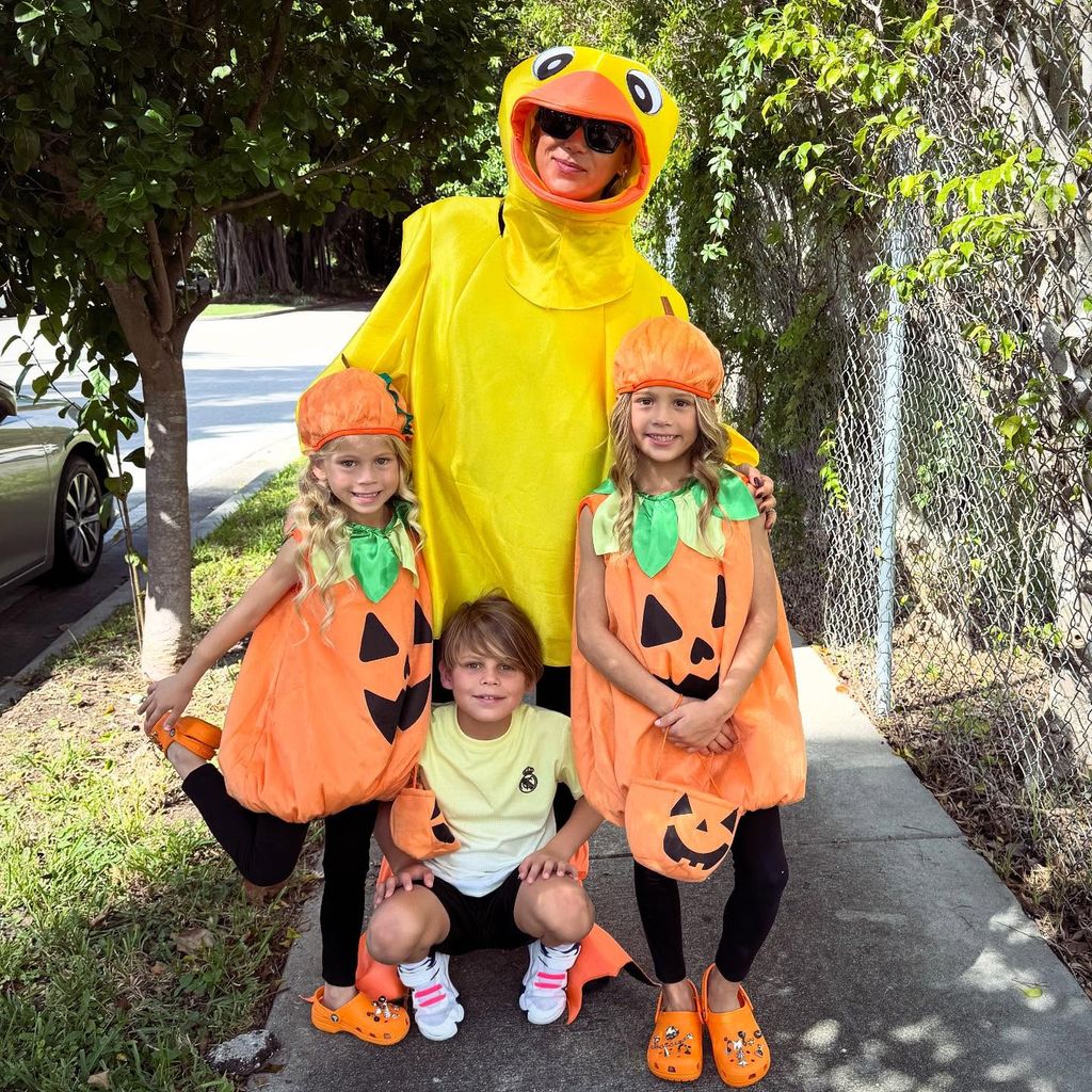 Anna Kournikova and her kids Lucy, Mary and Nicholas, dressed in Halloween costumes, pose for a photo by their home in Miami, shared on Instagram