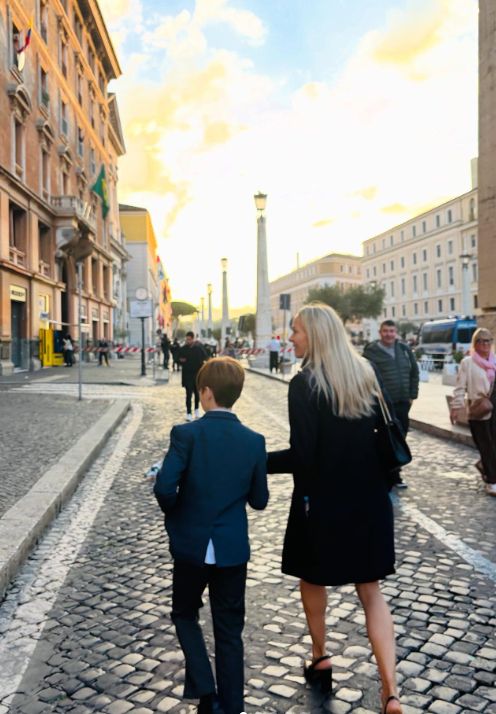 Cherry Healey and her son walking down a street