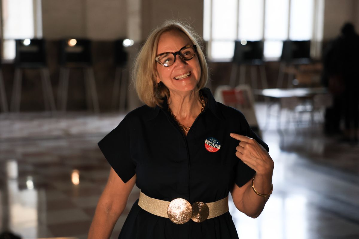 Miami Mayo Eileen Higgins points to her, "I Voted!', sticker after casting her ballot.