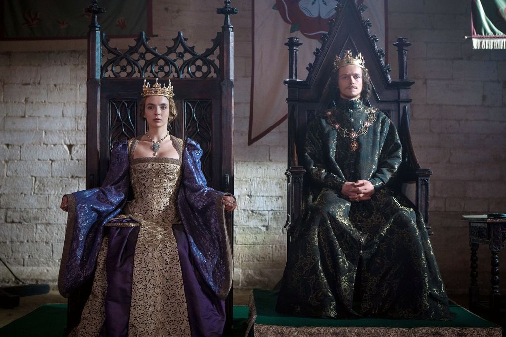 king and queen sitting on thrones