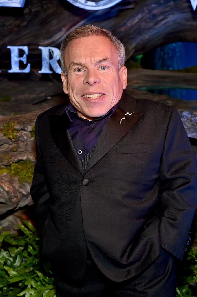 Warwick Davis in black suit poses for photos as he attends Lucasfilm and Imagine Entertainment's "Willow" Series Premiere in Los Angeles, California on November 29, 2022. The series debuts exclusively on Disney+ November 30, 2022