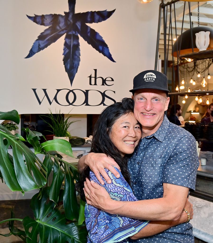 Laura Harrelson  in blue dress and Woody Harrelson in blue shirt attend 'The Woods' Opening Day