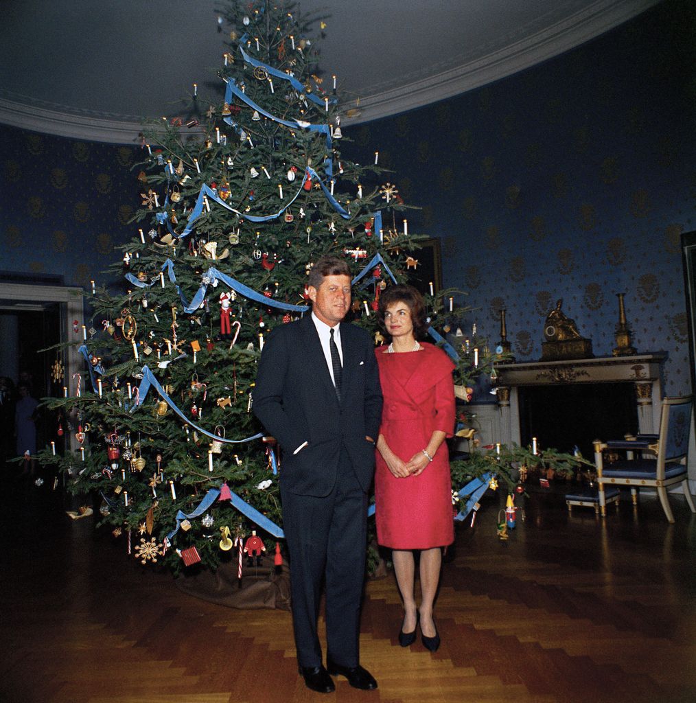 John F. Kennedy and U.S. First Lady Jacqueline Kennedy standing in front of Christmas tree in the Blue Room, White House, Washington, D.C., USA, Robert Knudsen, White House Photographs, December 13, 1961