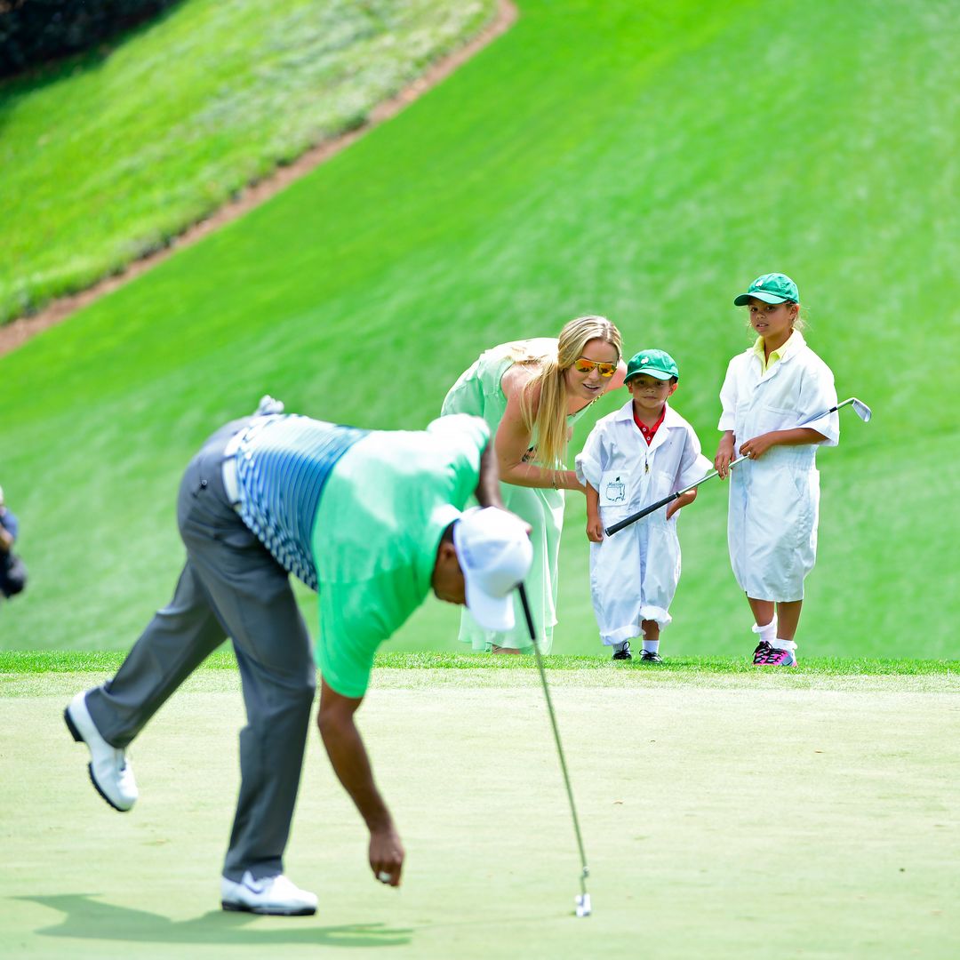 Masters champion Tiger Woods plays No. 1 with his children Sam and Charlie and girlfriend Lindsey Vonn during the Par 3 Contest for the Masters at Augusta National on Wednesday, April 8, 2015.