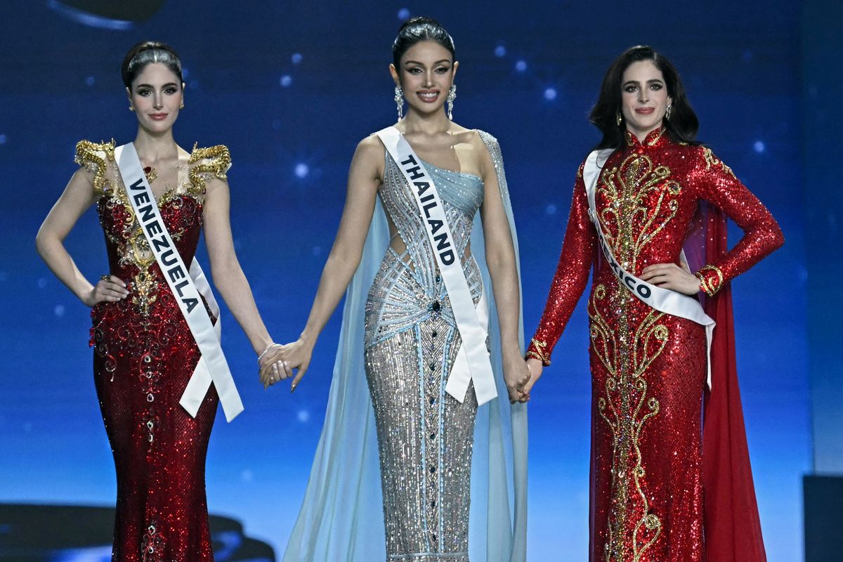 Miss Mexico Fatima Bosch (R), Miss Thailand Praveenar Singh (C) and Miss Venezuela Stephany Adriana Abasali Nasser (L) wait before the top two places are announced at the 2025 Miss Universe pageant. 