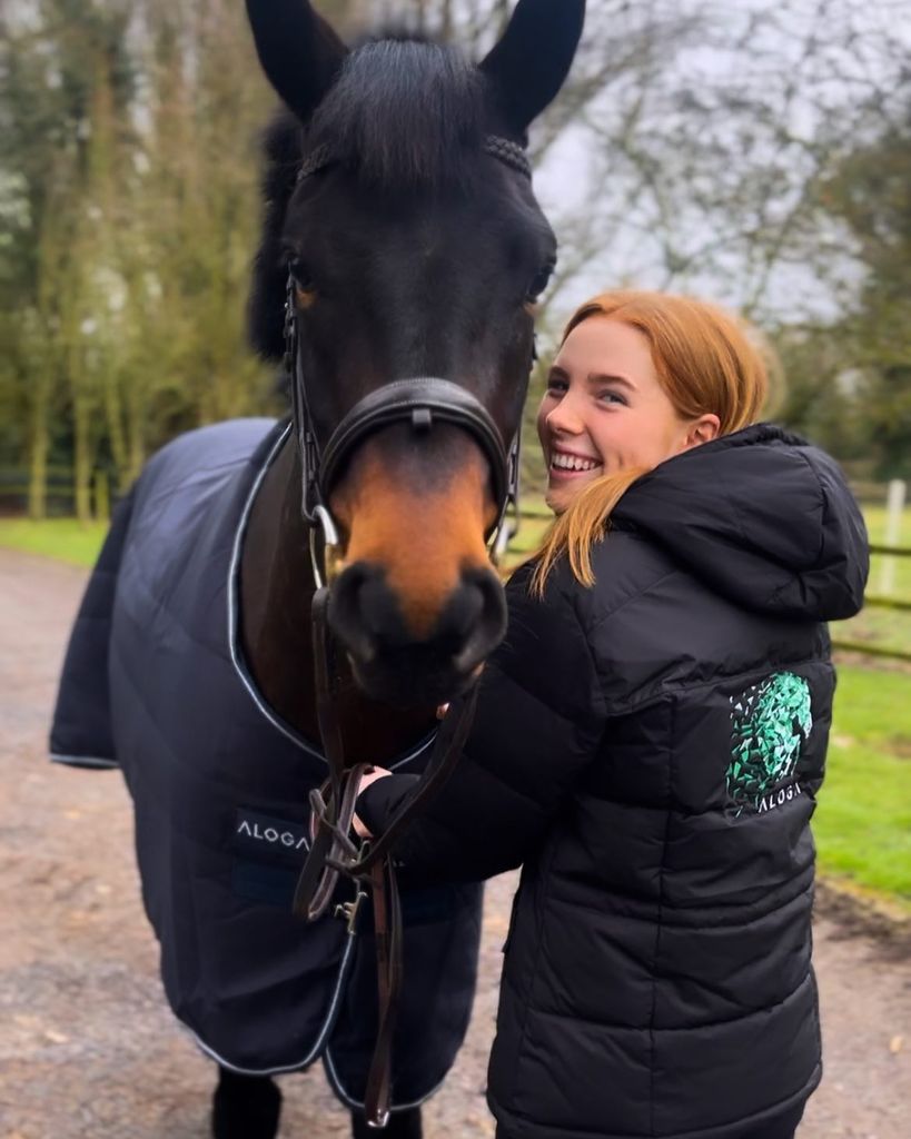 Ronan's daughter Ali in coat with horse