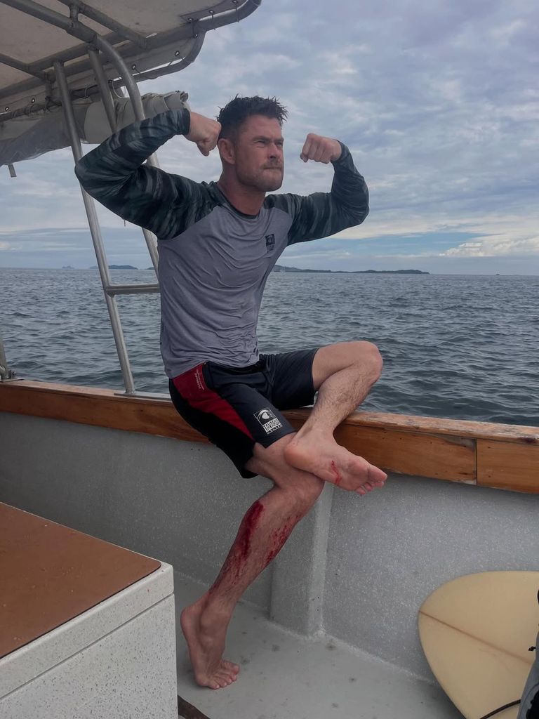 Chris poses on a boat while on vacation