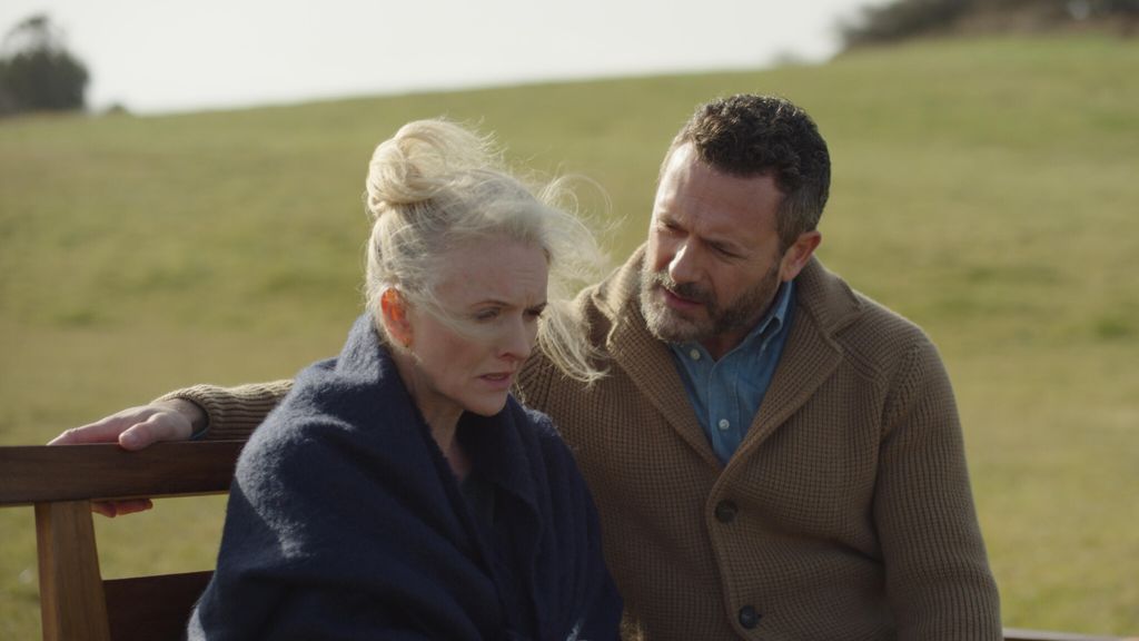 man and woman sitting on bench