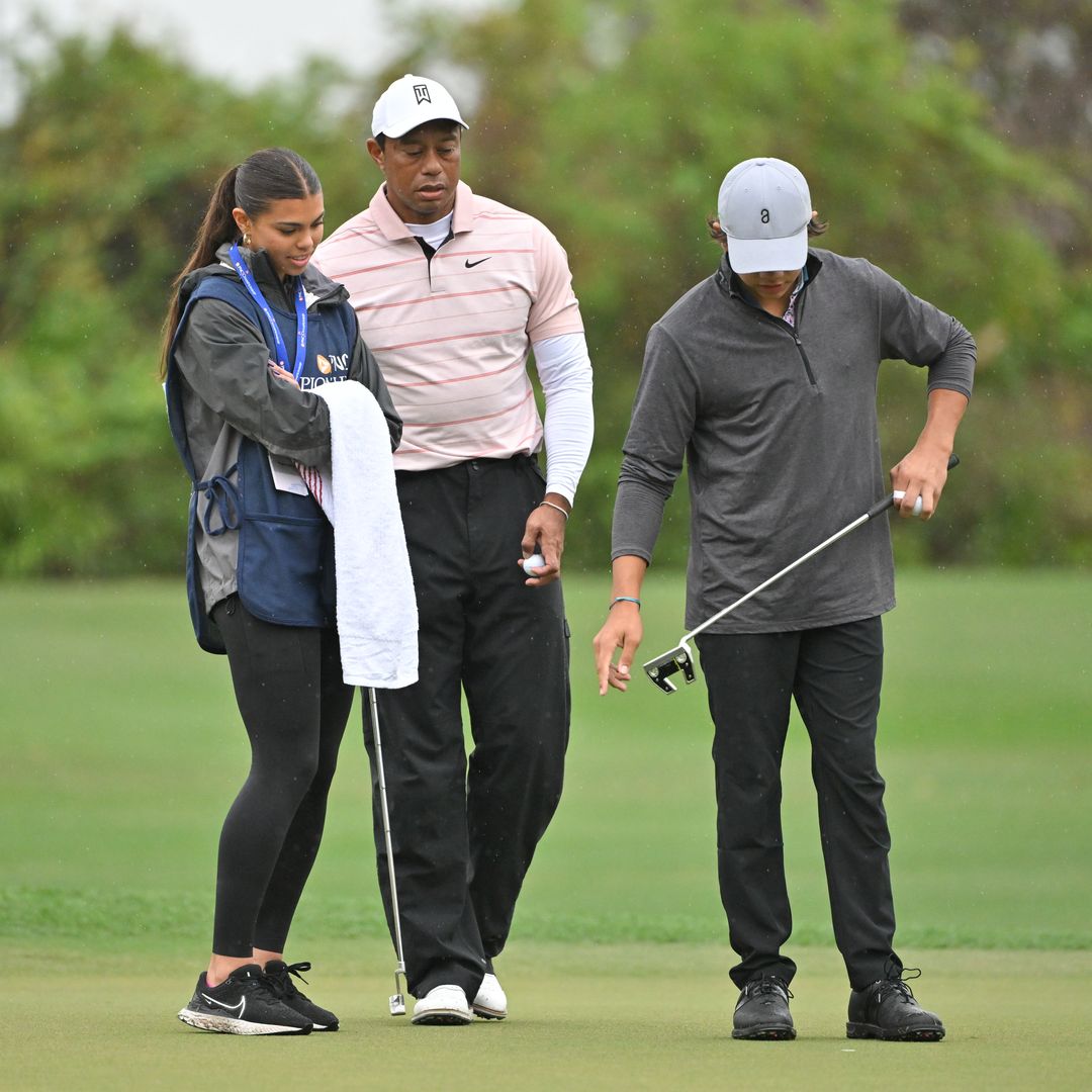Tiger Woods talks with his son and daughter, Charlie Woods and Sam Woods, on the third green during the first round of the PNC Championship at Ritz-Carlton Golf Club on December 16, 2023 in Orlando, Florida.