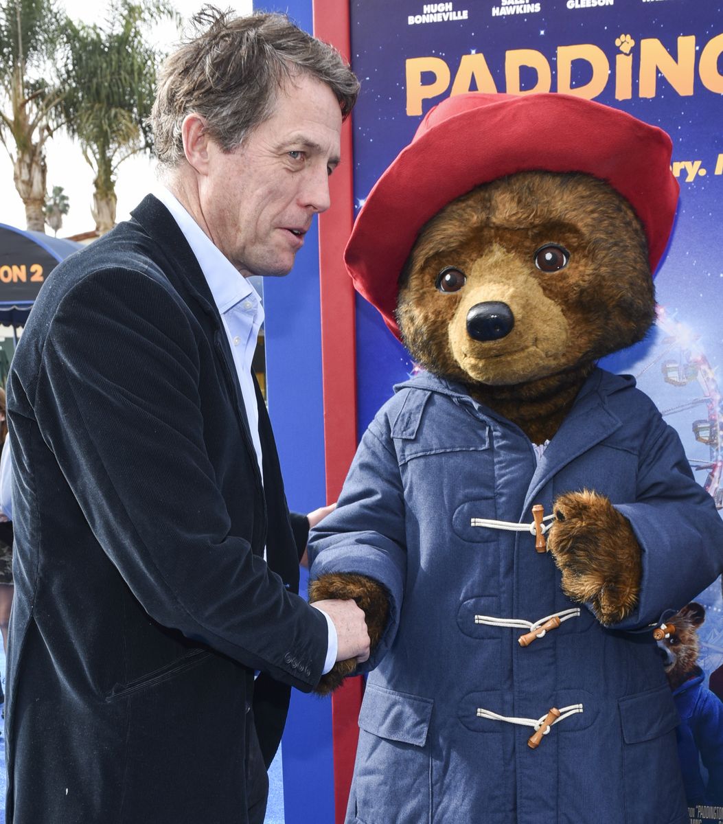 Hugh Grant greets Paddington Bear at the premiere of Warner Bros. Pictures' "Paddington 2" 