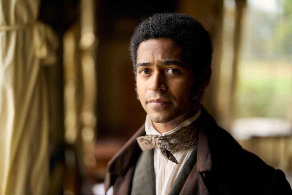 Man in period costume suit looking into camera