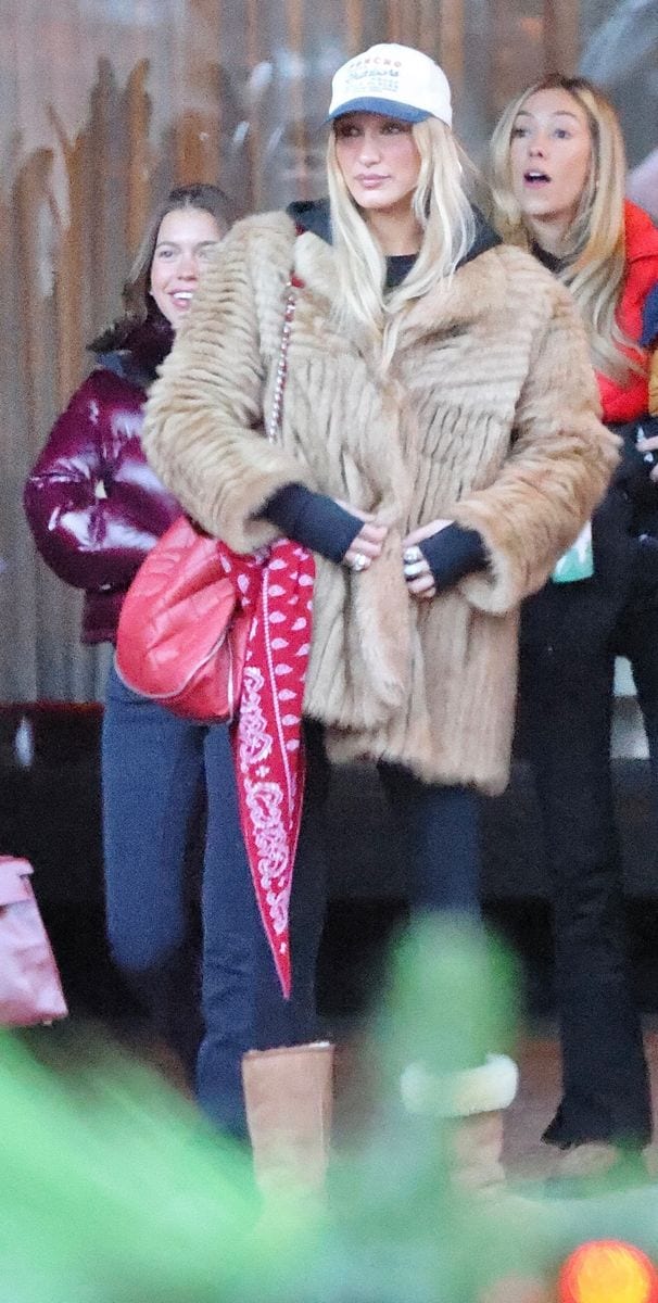 Bella Hadid’s outing included fitted black leggings and cozy knee-high tan Ugg boots. 