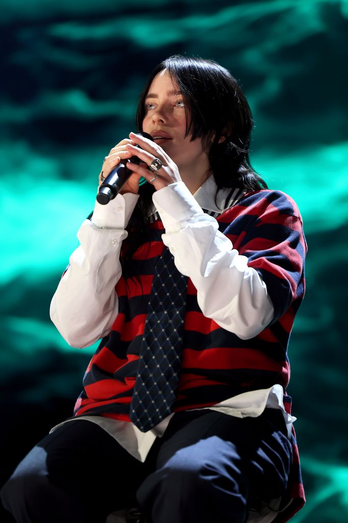 Billie Eilish in stripe shirt performs onstage during the FIREAID Benefit Concert for California Fire Relief 