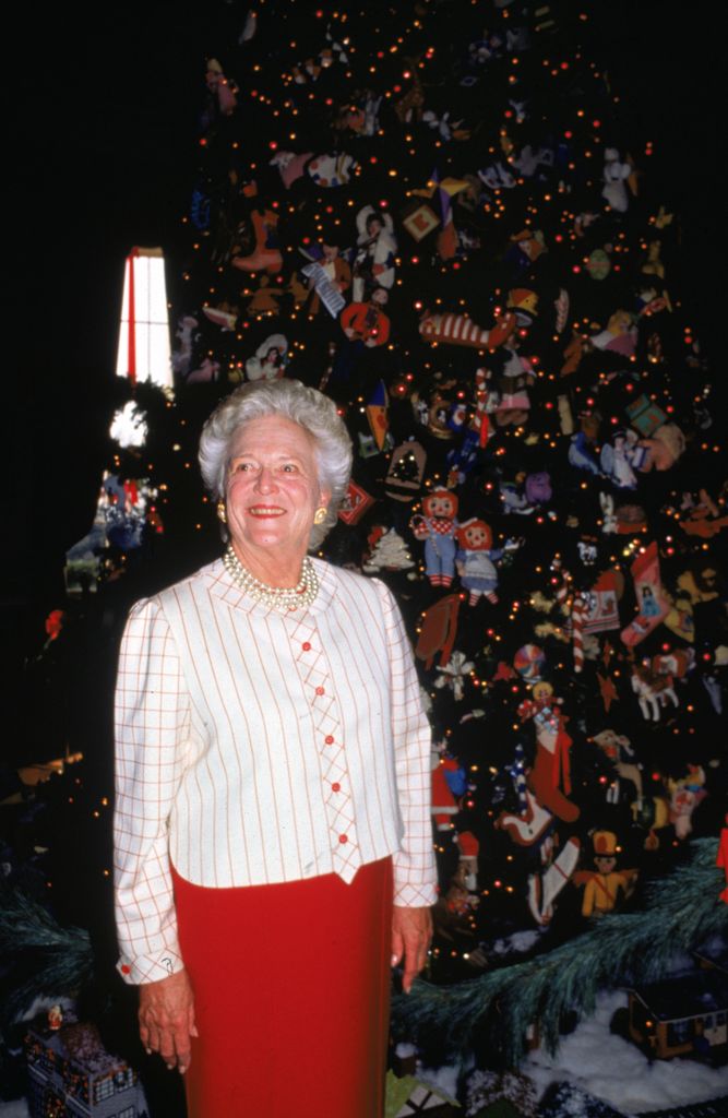  First Lady Barbara Pierce Bush, wife of President George Bush,  41st President of the United States, poses in front of one of the White House Christmas trees in the Blue Room, Washington, D.C, 1991