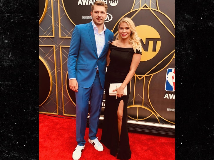 Luka Doncic and his fiancee Anamaria Goltes are seen at the NBA Awards ceremony. He's wearing a blue jacket and matching pants, while she opted for a black dress,, which was offset by a white clutch.