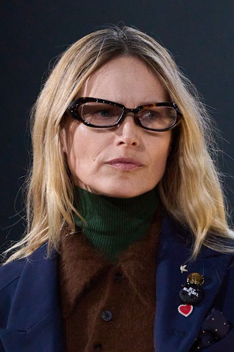 model wearing glasses in a blue blazer 