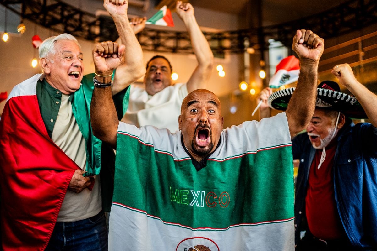 Mexican fans mix sombreros with lucha libre masks.