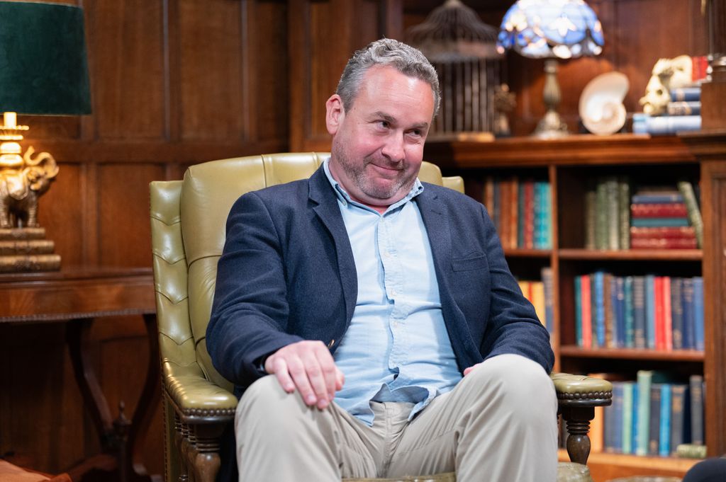 man sitting in arm chair