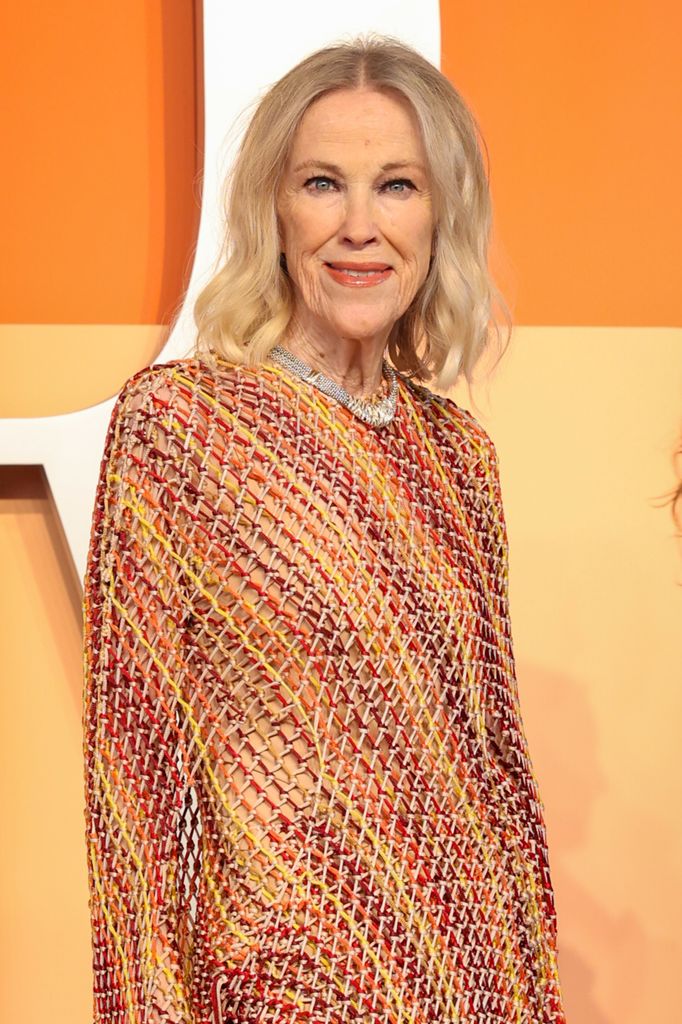 Catherine O'Hara in orange dress at the 2025 Vanity Fair Oscar Party 