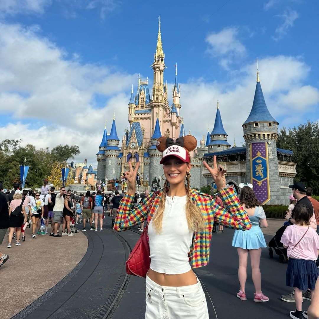Hadid standing next to Cinderella's castle
