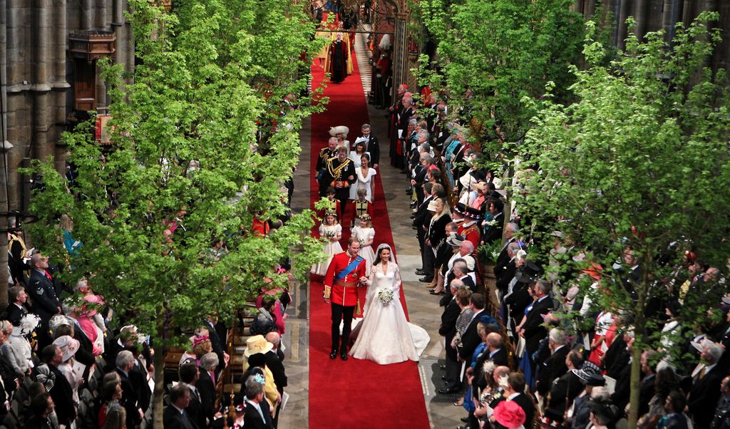 William and Kate walking down the tree-lined aisle at their wedding