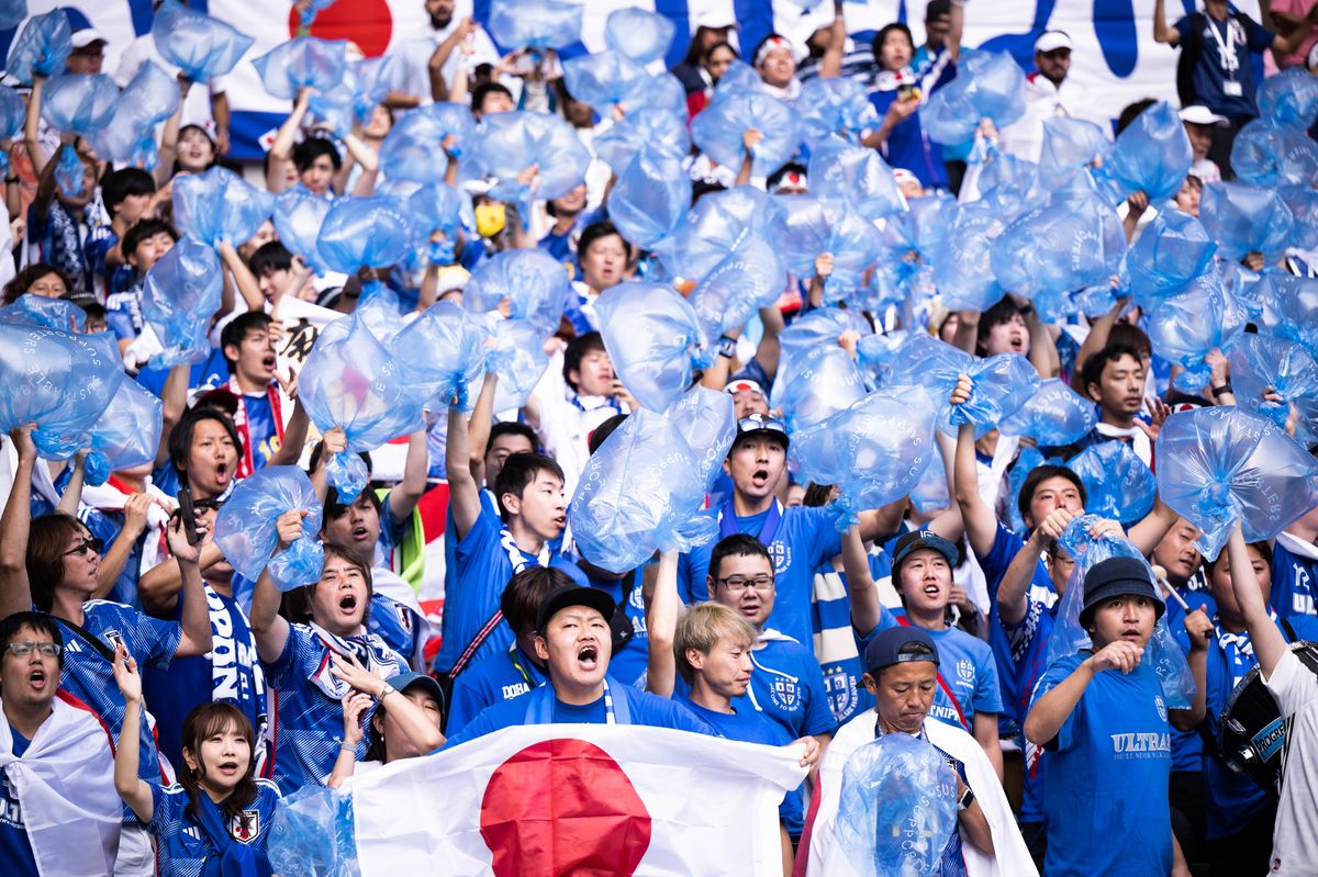 Fans of Japan are carrying garbage bags for cleaning afterwards before the FIFA World Cup Qatar 2022.