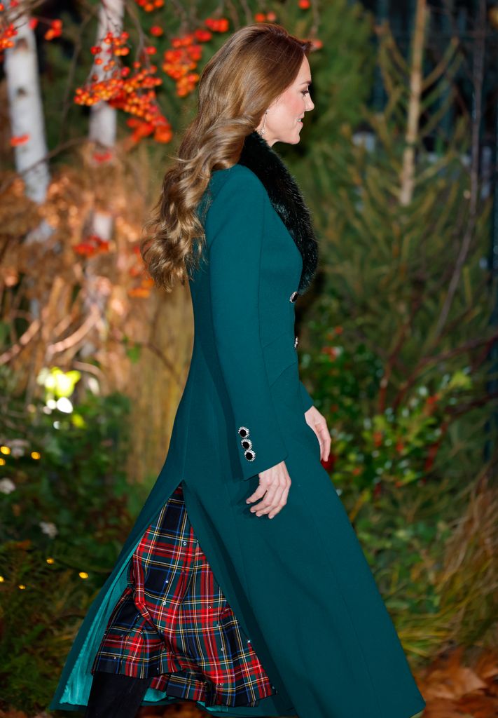 The Princess of Wales side on in green coat and tartan skirt
