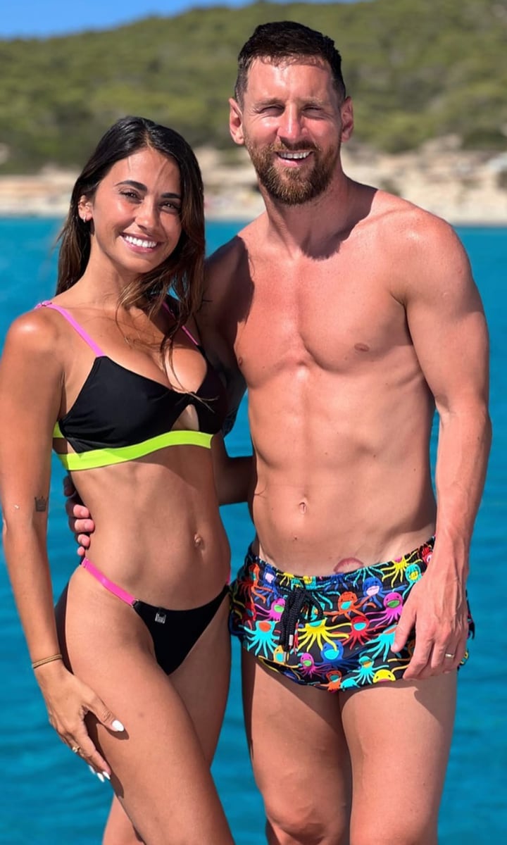 The celebrity couple was all smiles during one of their tropical outings. Antonela wore a black bikini with neon pink and green straps, while Leo wore matching black shorts with a colorful print.