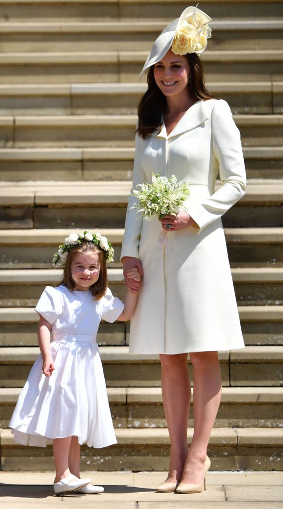 Princess Charlotte and catherine stand on steps in white dresses