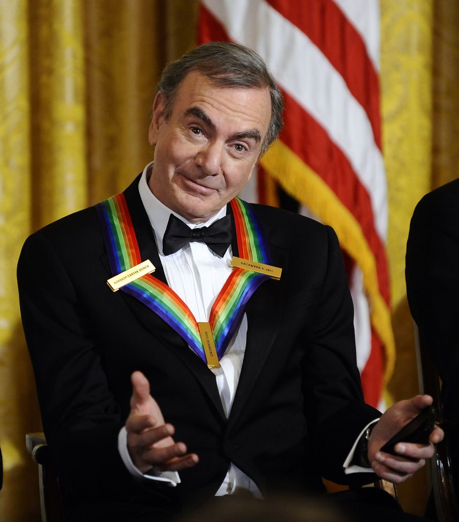 Kennedy Center Honoree songwriter Neil Diamond reacts as US President speaks during a reception in the East Room of the White House in Washington, DC, on December 4, 2011. 