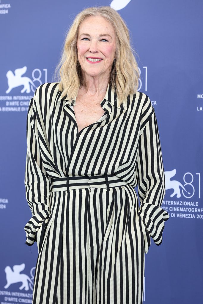 Catherine O'Hara in a black-and-white striped dress