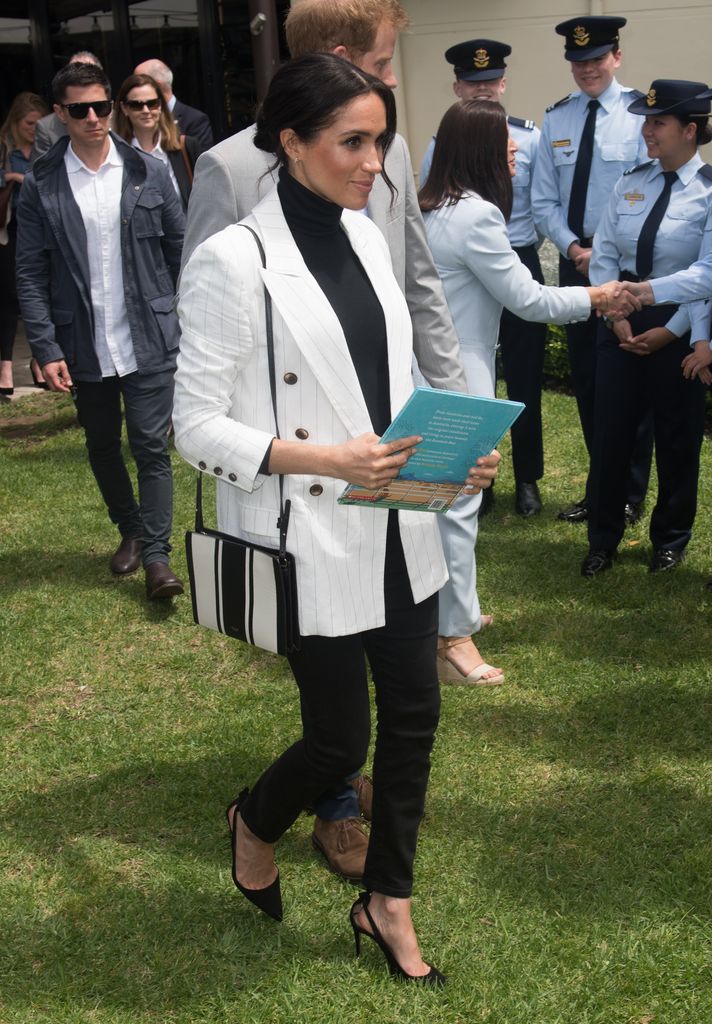 Meghan Sussex rocked a L'Agence blazer with skinny jeans and a striped bag during a visit to Australia