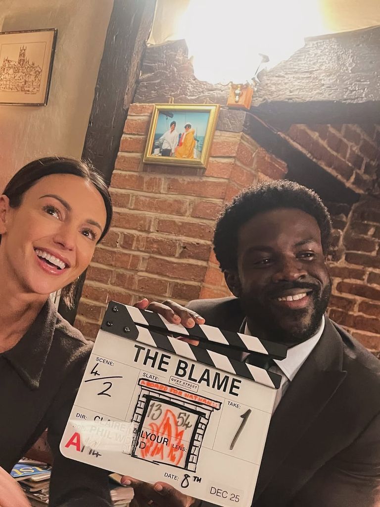 Michelle Keegan and Nathan Mensah holding clapperboard behind the scenes of The Blame