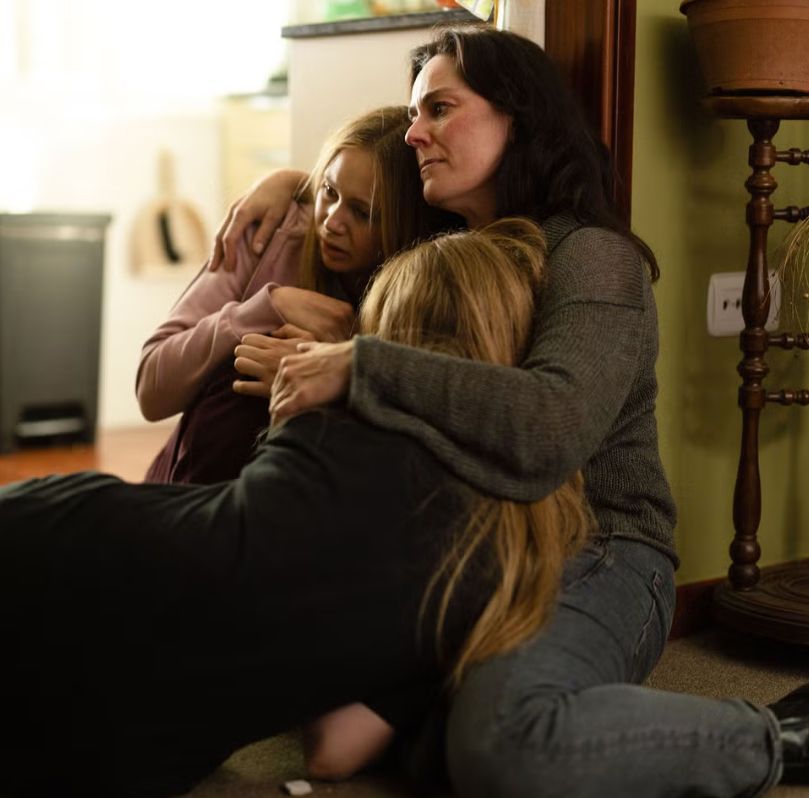 Jill Halfpenny cradling two girls in a still from Girl Taken