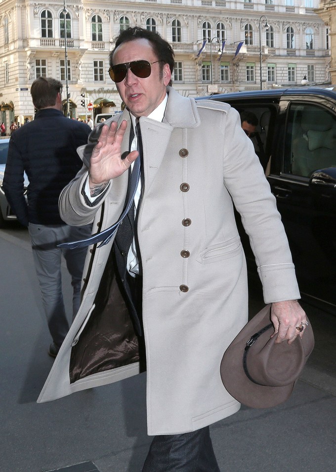 Nicolas Cage looks dapper in a grey coat