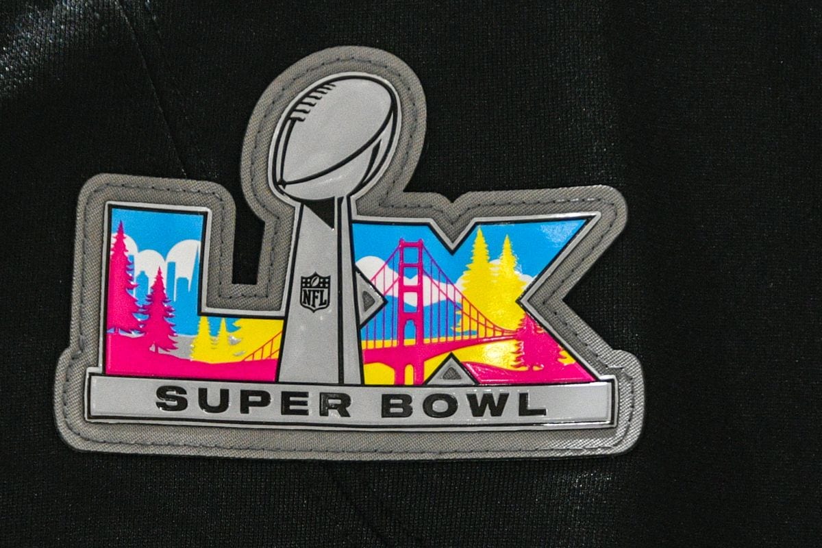 A detailed view of a Super Bowl LX logo patch on New England Patriots jerseys.
