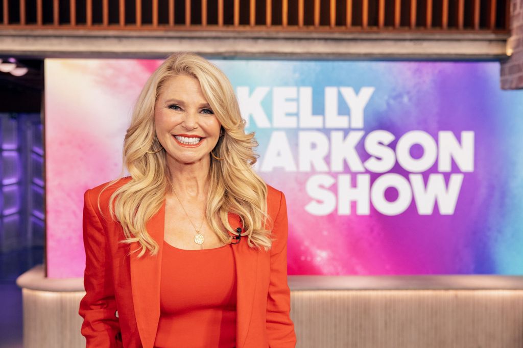 Christie Brinkley in orange pantsuit 