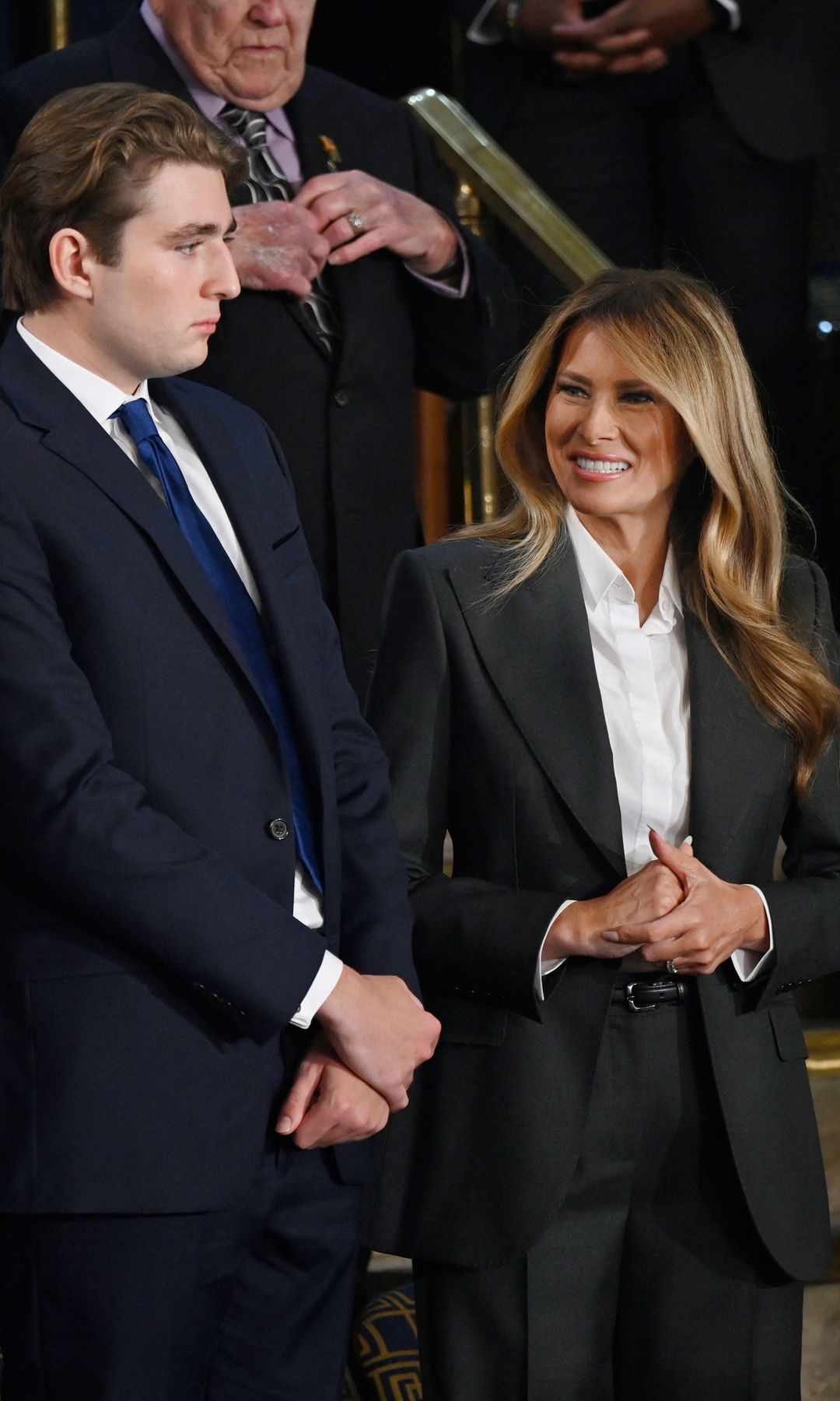 First Lady Melania Trump made a rare but commanding appearance in a sharply tailored dark gray pantsuit from Dolce & Gabbana.
