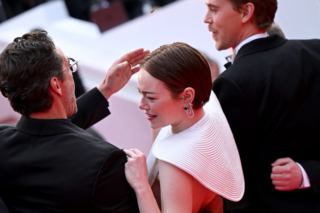Pedro Pascal swatting a bee away from Emma Stone